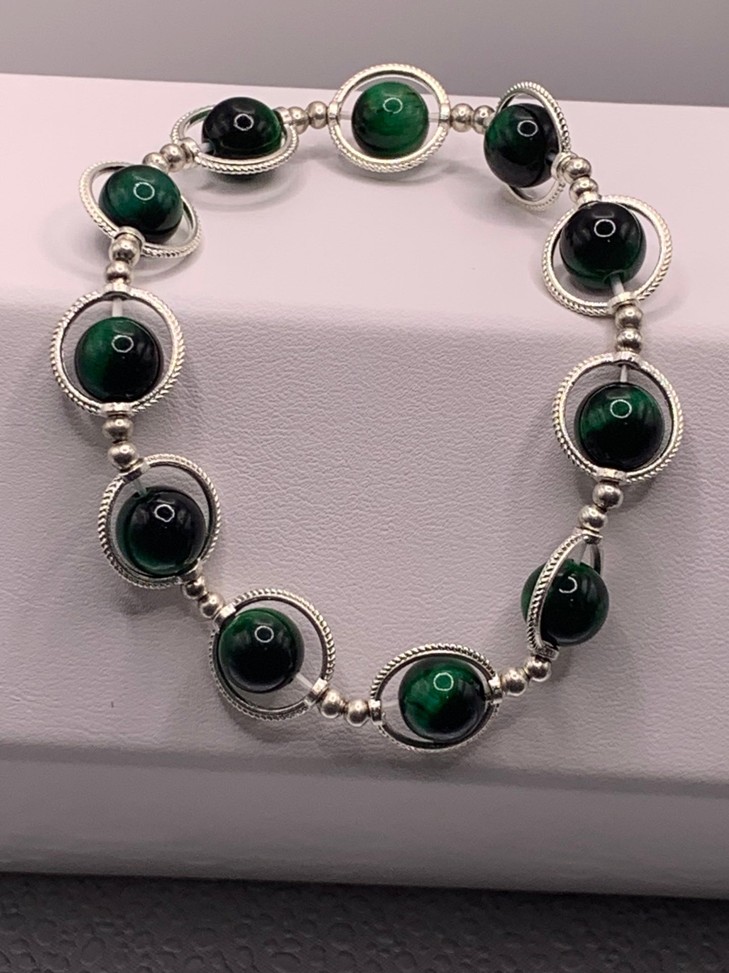 Green tigers eye semi precious stone/crystal elastic beaded bracelet with silver colored rings