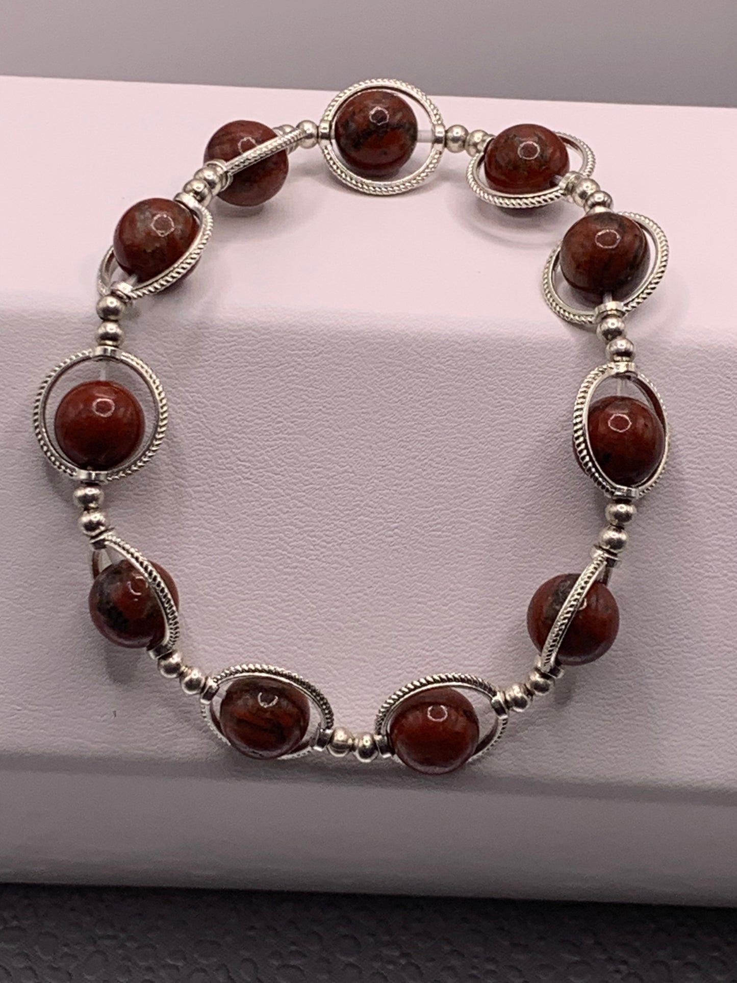 Red sesame jasper semi precious stone/crystal elastic beaded bracelet with silver colored rings