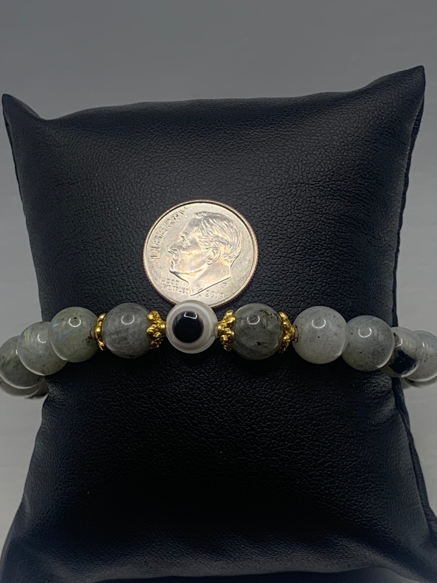 This bracelet features labradorite beads and a colorful evil eye resin bead with gold flower caps. These are 8mm beads, made with elastic string to stretch onto the wrist and is approximately 17 cm or 6.7 inches
These are natural semi-precious stones/crystals. Even if they are dyed, the base material is still natural and imperfections are common making them unique