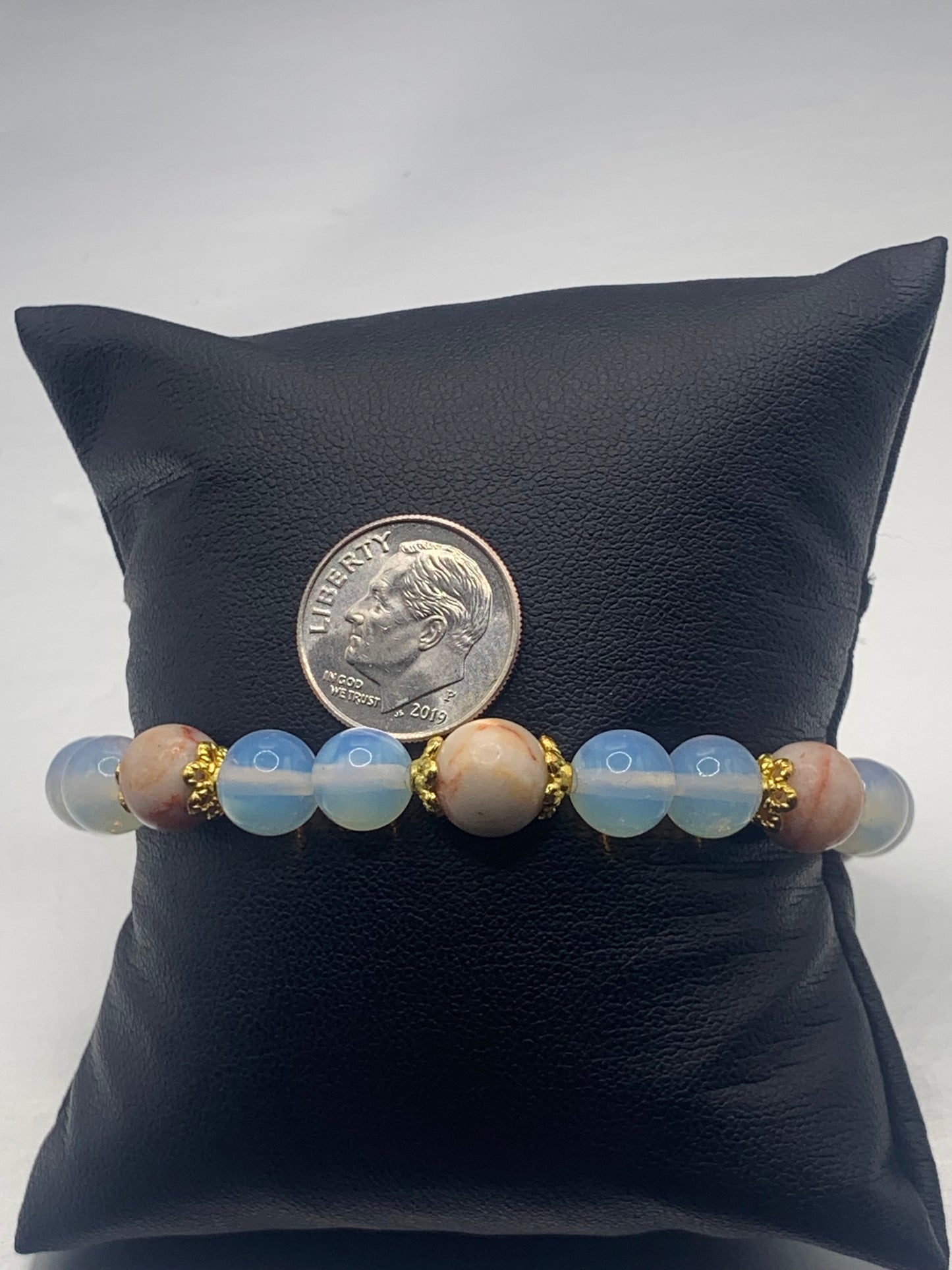 Red vein jasper and opalite semi precious stone/crystal elastic beaded bracelet with gold plated flower bead caps