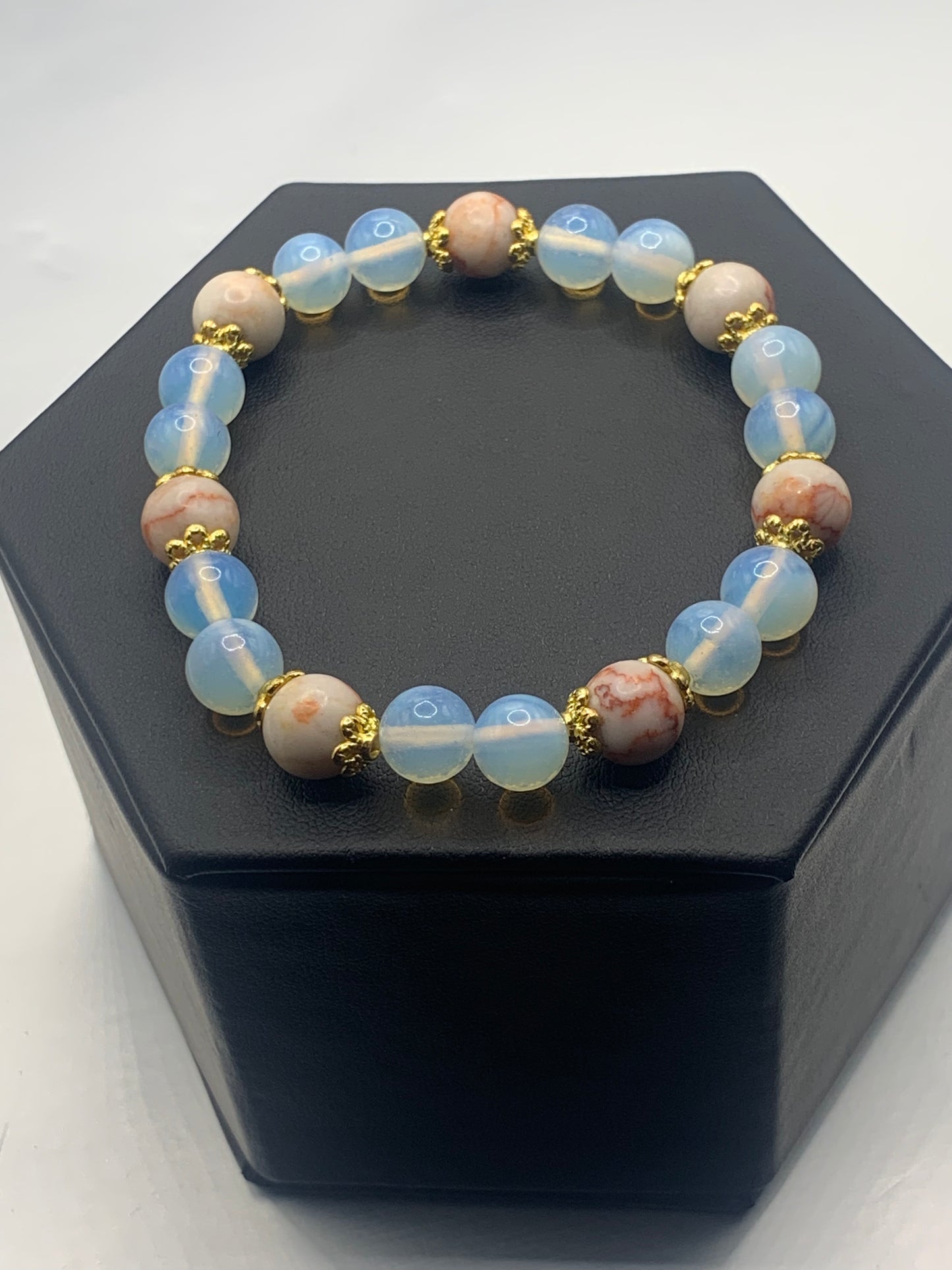Red vein jasper and opalite semi precious stone/crystal elastic beaded bracelet with gold plated flower bead caps
