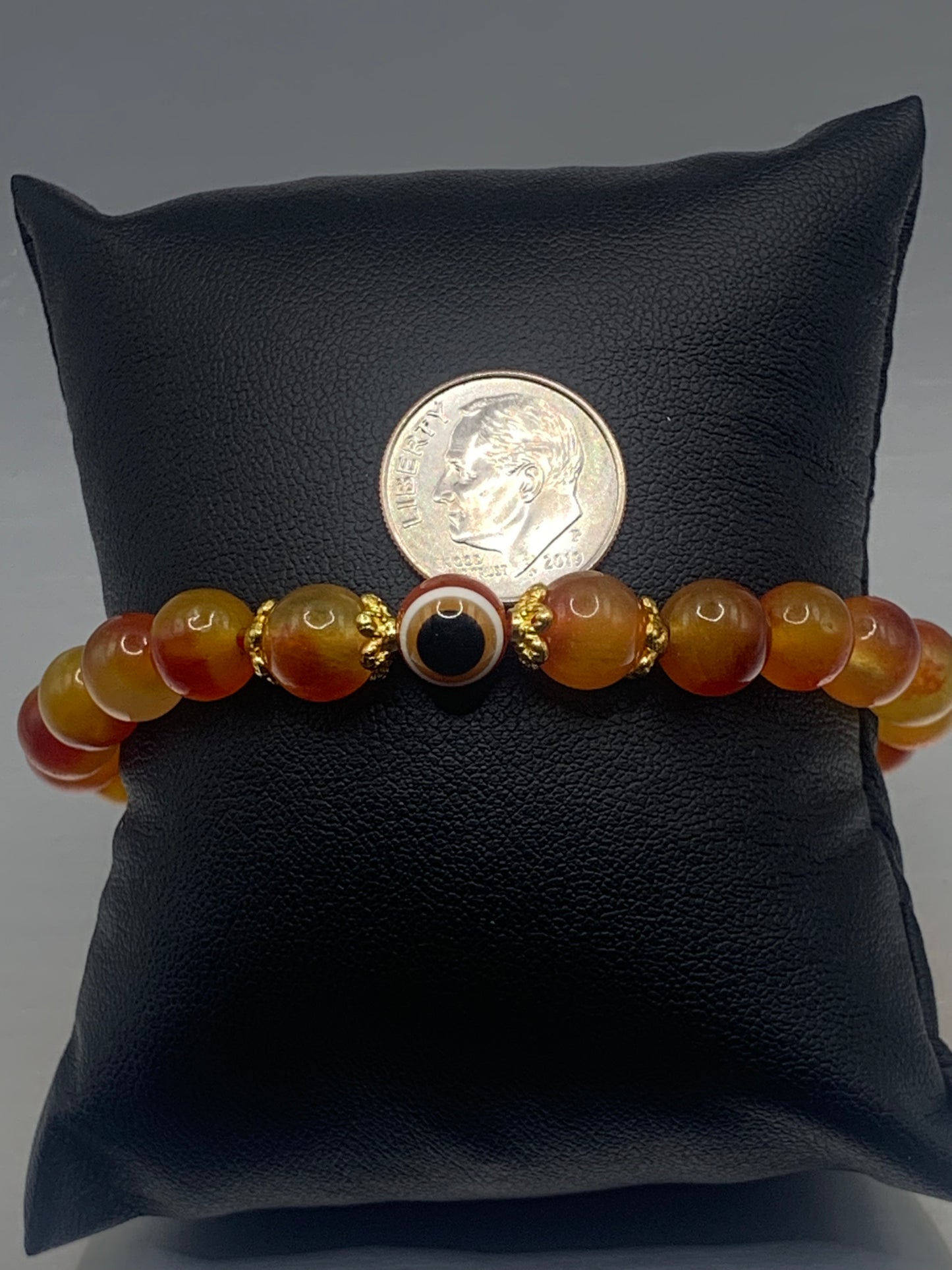 This bracelet features orange blossom agate beads and a colorful evil eye resin bead with gold flower caps. These are 8mm beads, made with elastic string to stretch onto the wrist and is approximately 17 cm or 6.7 inches
These are natural semi-precious stones/crystals. Even if they are dyed, the base material is still natural and imperfections are common making them unique