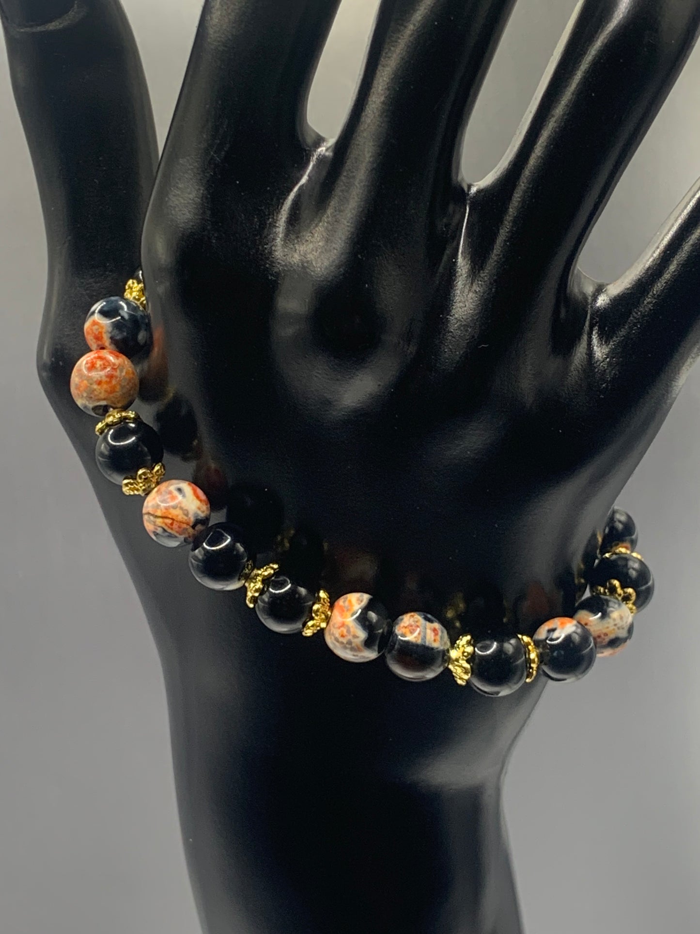 Black obsidian with orange orca agate semi precious stone/crystal beaded elastic bracelet with gold plated flower bead caps