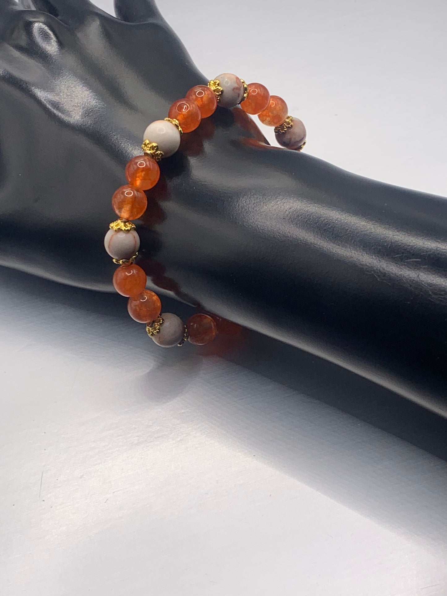 Red vein jasper and phoenix agate semi precious stone/crystal elastic beaded bracelet with gold plated flower bead caps