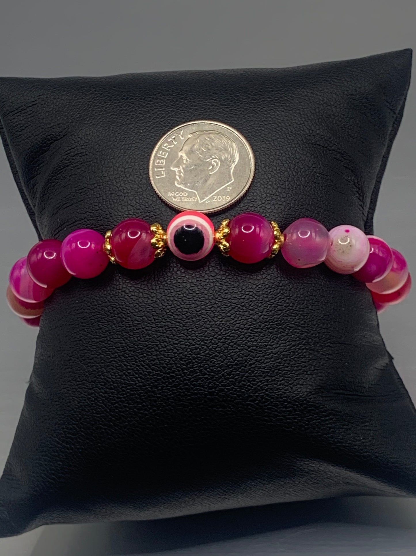 This bracelet features pink lace agate beads and a colorful evil eye resin bead with gold flower caps. These are 8mm beads, made with elastic string to stretch onto the wrist and is approximately 17 cm or 6.7 inches
These are natural semi-precious stones/crystals. Even if they are dyed, the base material is still natural and imperfections are common making them unique