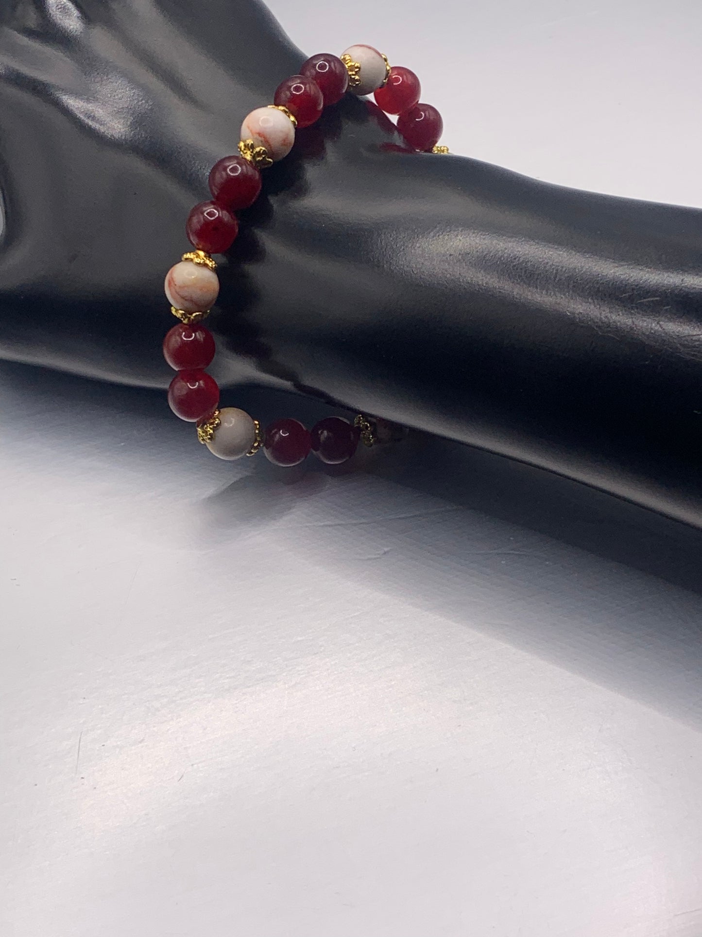 Red vein jasper and red chalcedony semi precious stone/crystal elastic beaded bracelet with gold plated flower bead caps