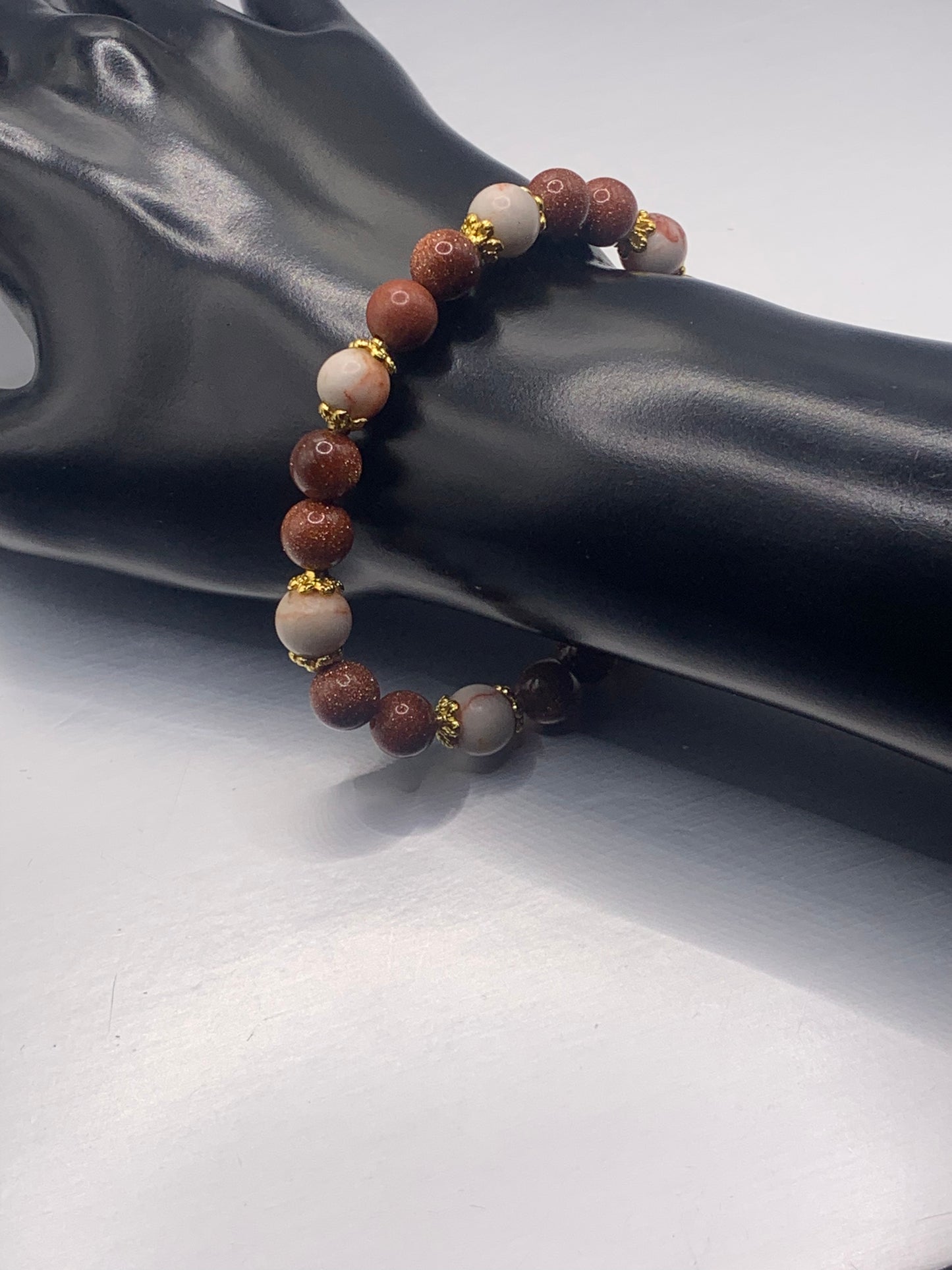 Red vein jasper and sandstone semi precious stone/crystal elastic beaded bracelet with gold plated flower bead caps