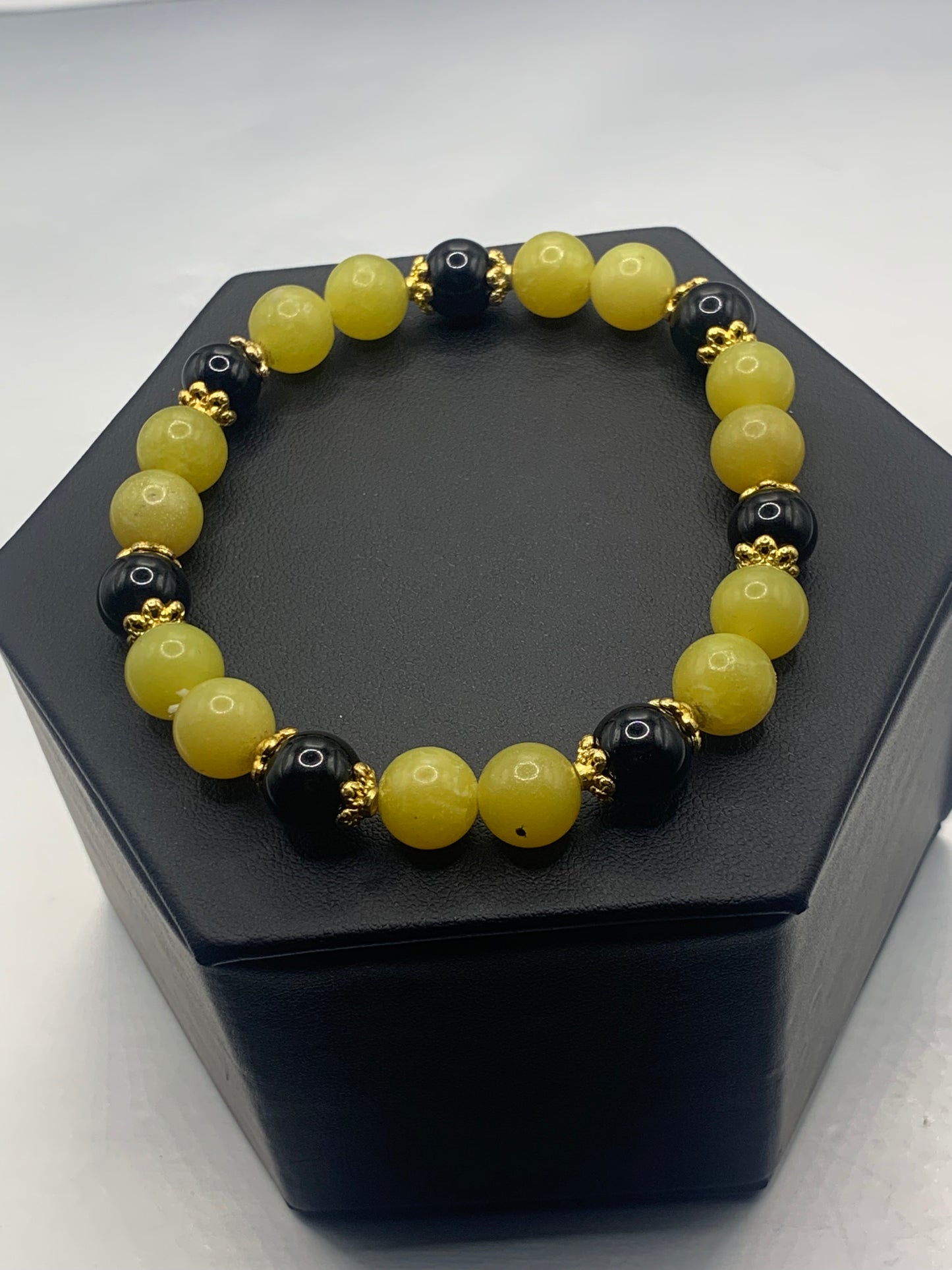 Black obsidian with yellow jade semi precious stone/crystal beaded elastic bracelet with gold plated flower bead caps