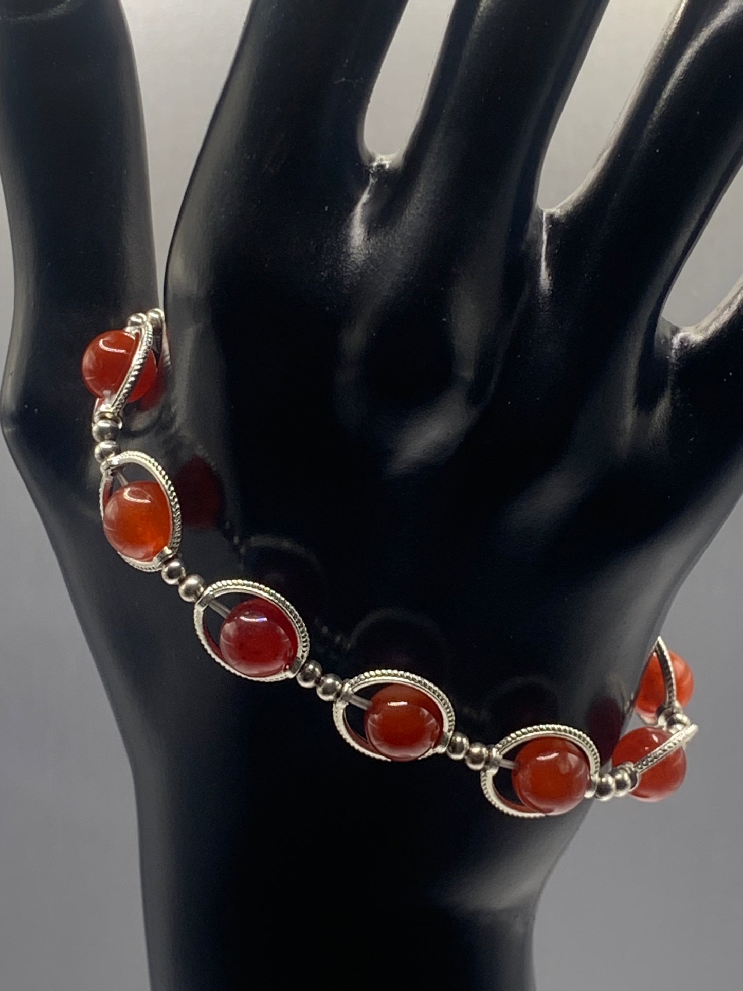 Red agate semi precious stone/crystal elastic beaded bracelet with silver colored rings