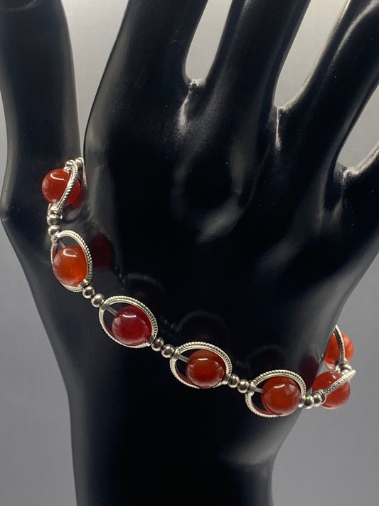Red agate semi precious stone/crystal elastic beaded bracelet with silver colored rings