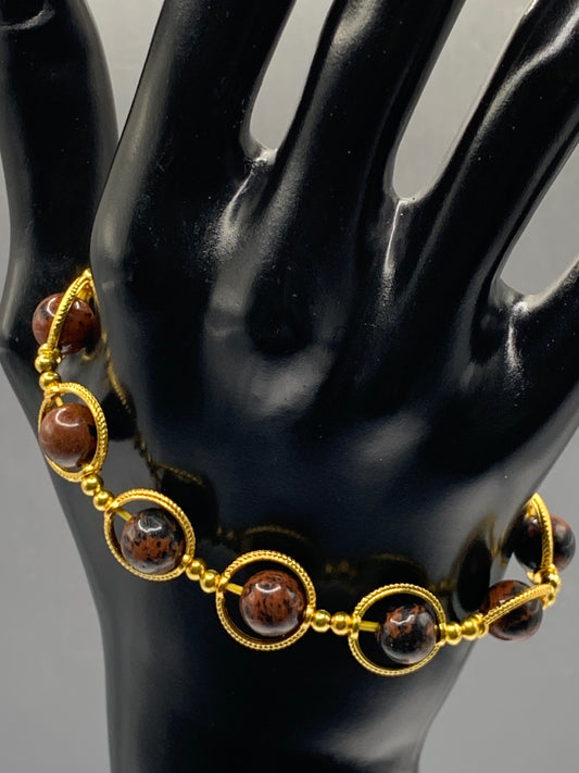 Mahogany jasper semi precious stone/crystal elastic beaded bracelet with gold colored rings