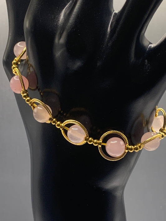 Rose quartz semi precious stone/crystal elastic beaded bracelet with gold colored rings