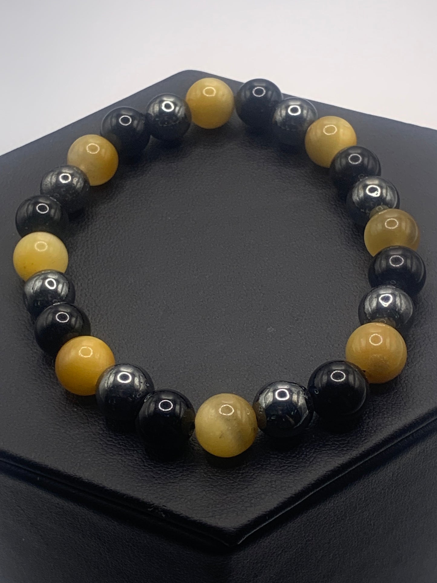 Hematite, black obsidian, and yellow tigers eye semi precious stone/crystal elastic beaded bracelet
