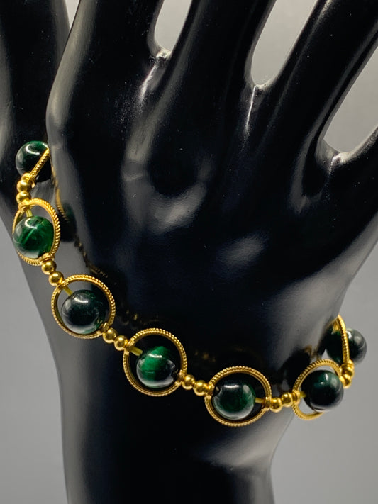 Green tigers eye semi precious stone/crystal elastic beaded bracelet with gold colored rings