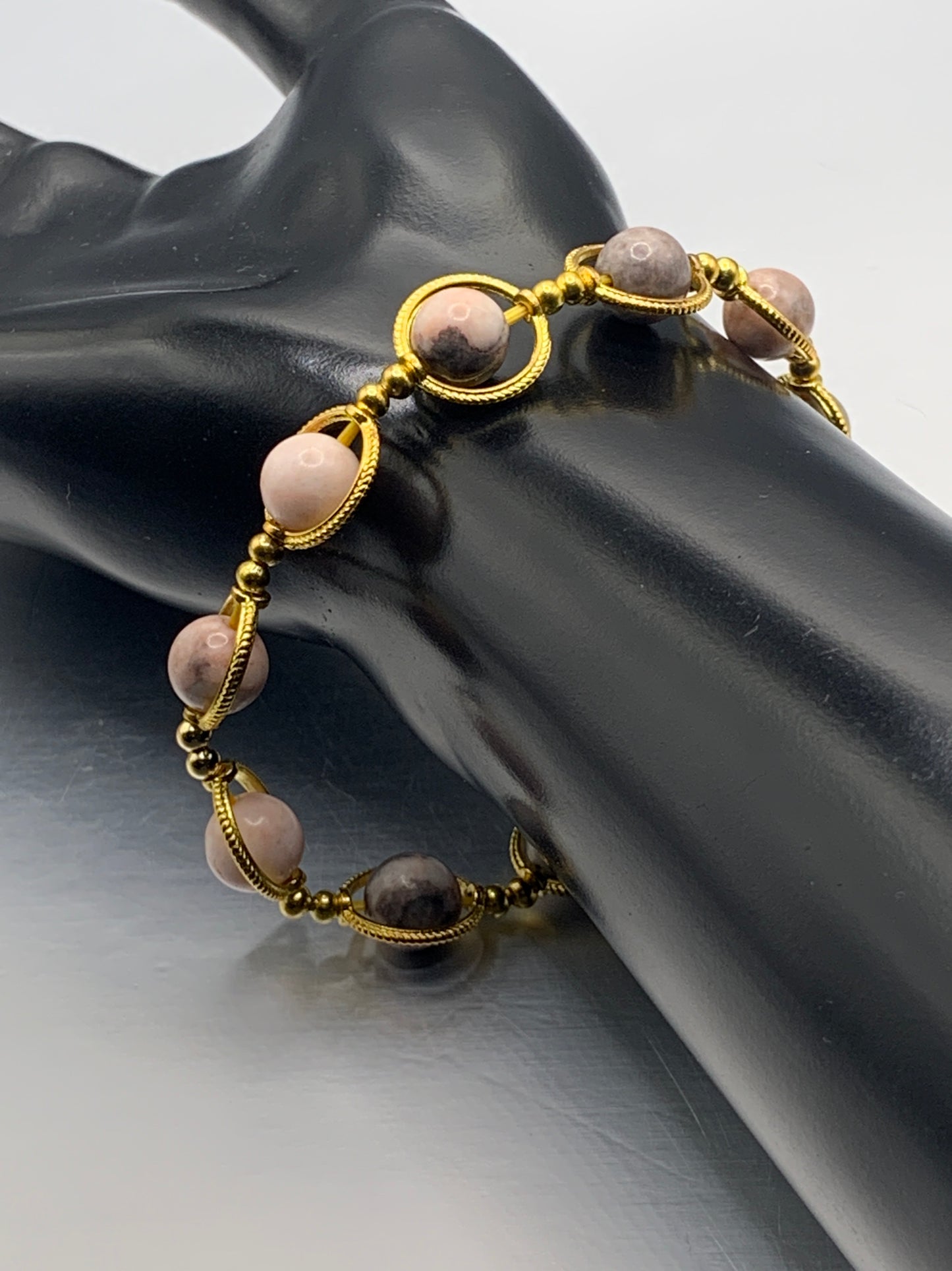 Pink zebra jasper semi precious stone/crystal elastic beaded bracelet with gold colored rings