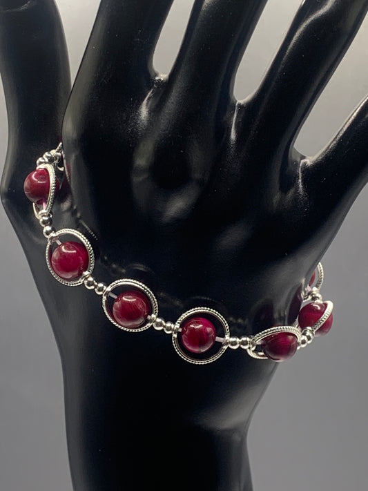 Pink tigers eye semi precious stone/crystal elastic beaded bracelet with silver colored rings