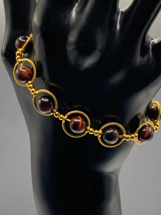 Red tigers eye semi precious stone/crystal elastic beaded bracelet with gold colored rings