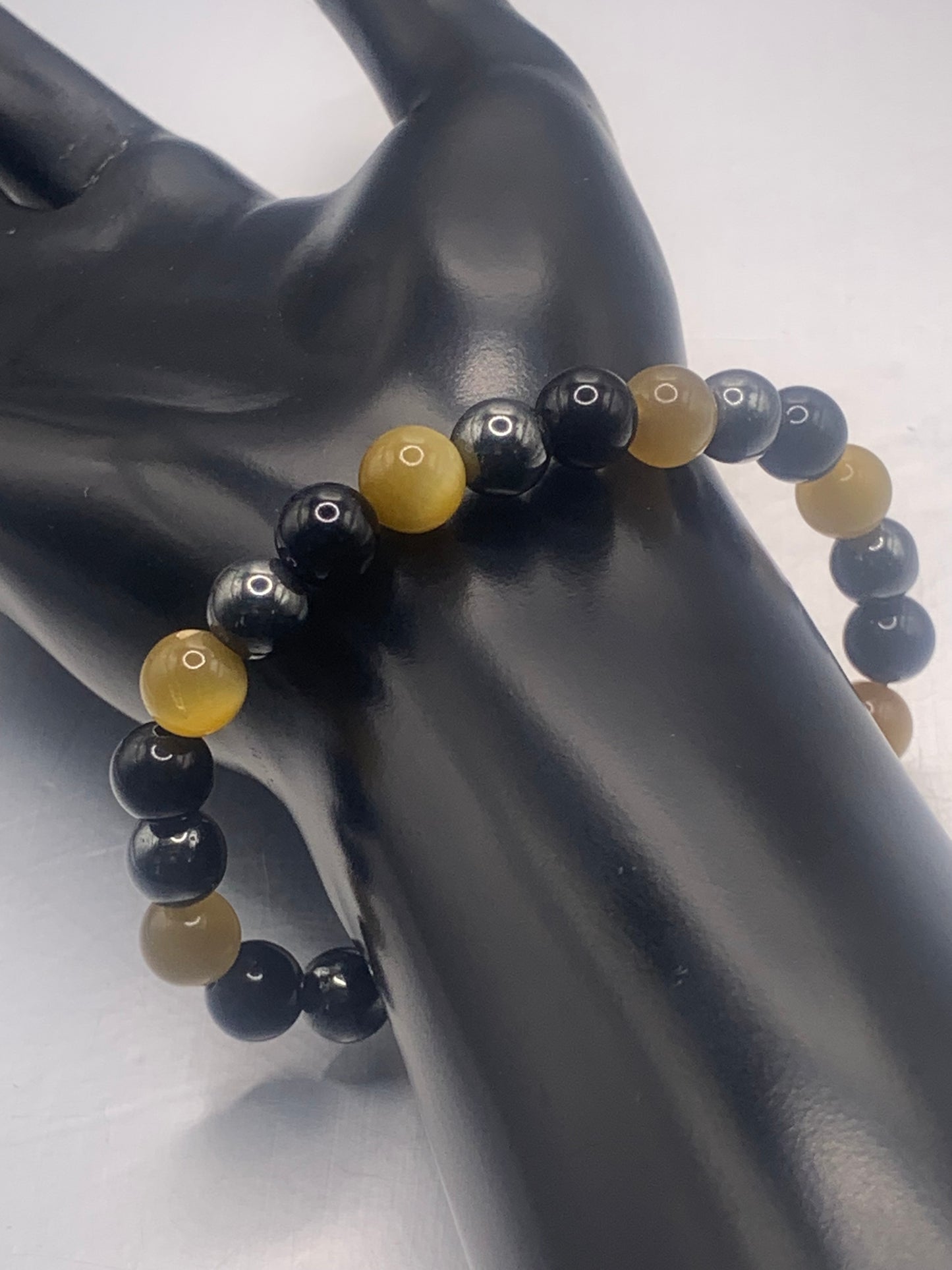 Hematite, black obsidian, and yellow tigers eye semi precious stone/crystal elastic beaded bracelet