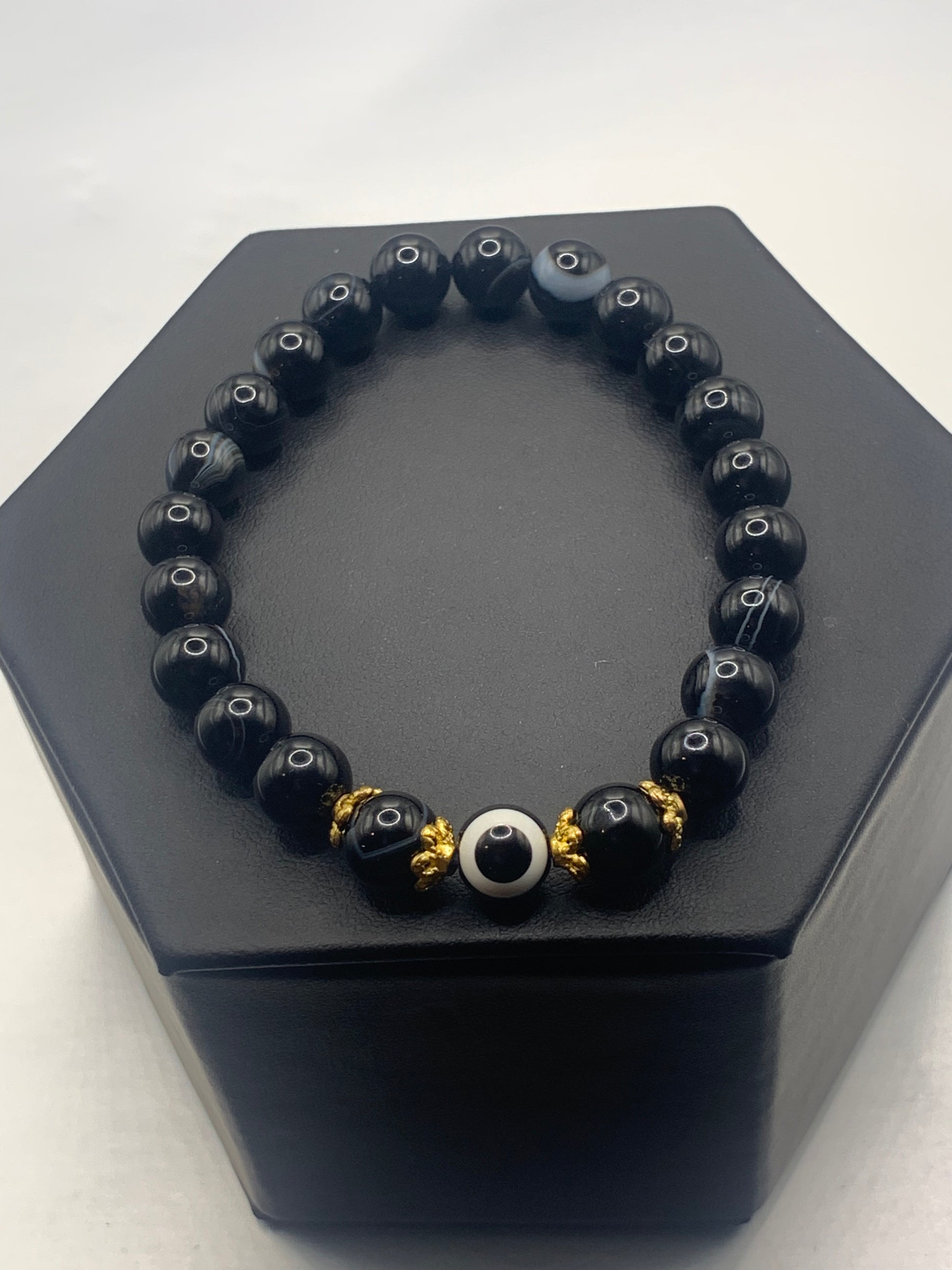 This bracelet features black lace agate beads and a colorful evil eye resin bead with gold flower caps. These are 8mm beads, made with elastic string to stretch onto the wrist and is approximately 17 cm or 6.7 inches



These are natural semi-precious stones/crystals. Even if they are dyed, the base material is still natural and imperfections are common making them unique