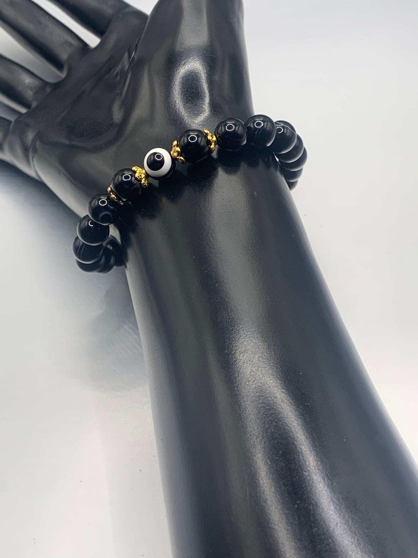 This bracelet features black lace agate beads and a colorful evil eye resin bead with gold flower caps. These are 8mm beads, made with elastic string to stretch onto the wrist and is approximately 17 cm or 6.7 inches



These are natural semi-precious stones/crystals. Even if they are dyed, the base material is still natural and imperfections are common making them unique