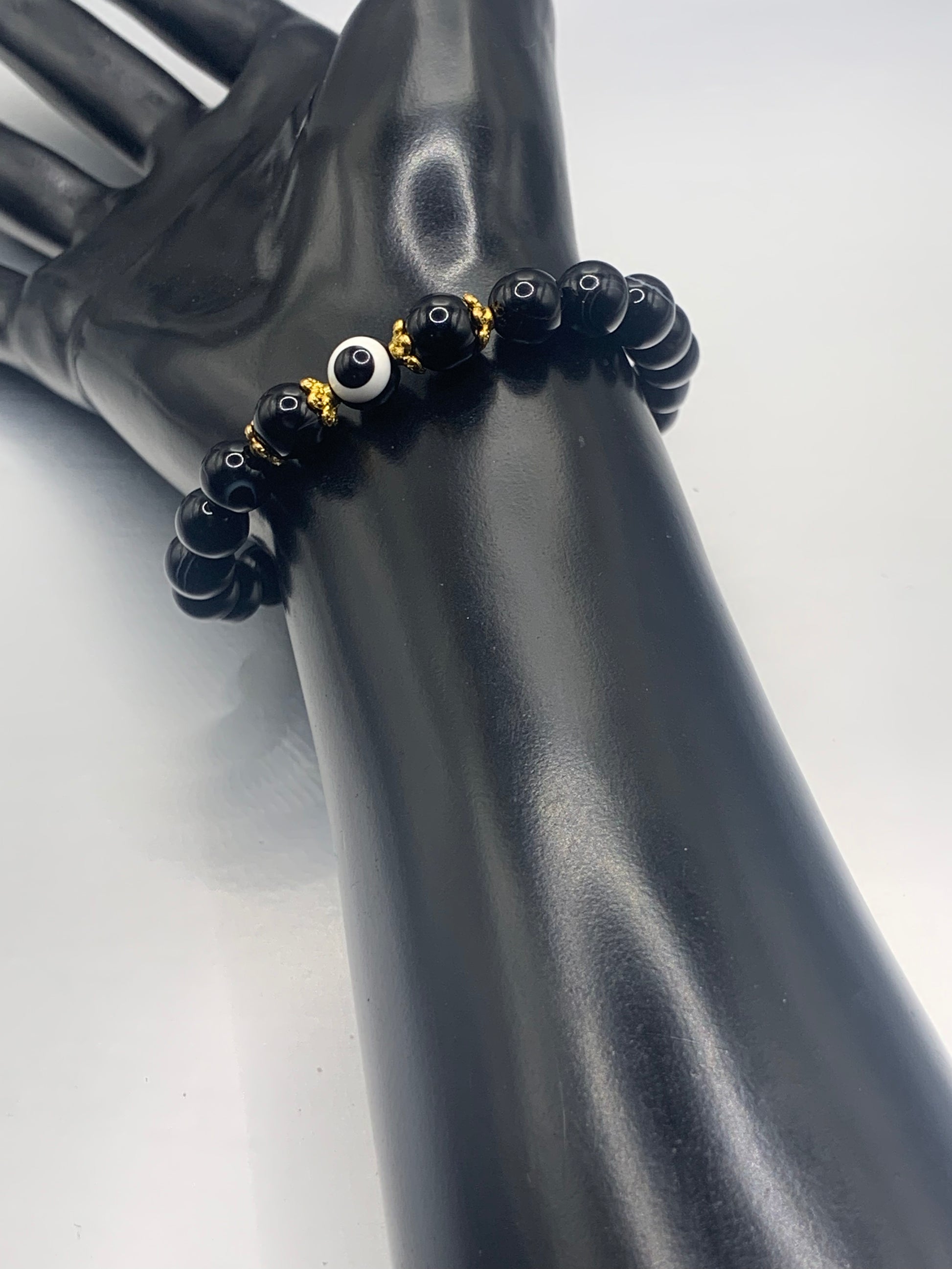 This bracelet features black lace agate beads and a colorful evil eye resin bead with gold flower caps. These are 8mm beads, made with elastic string to stretch onto the wrist and is approximately 17 cm or 6.7 inches



These are natural semi-precious stones/crystals. Even if they are dyed, the base material is still natural and imperfections are common making them unique