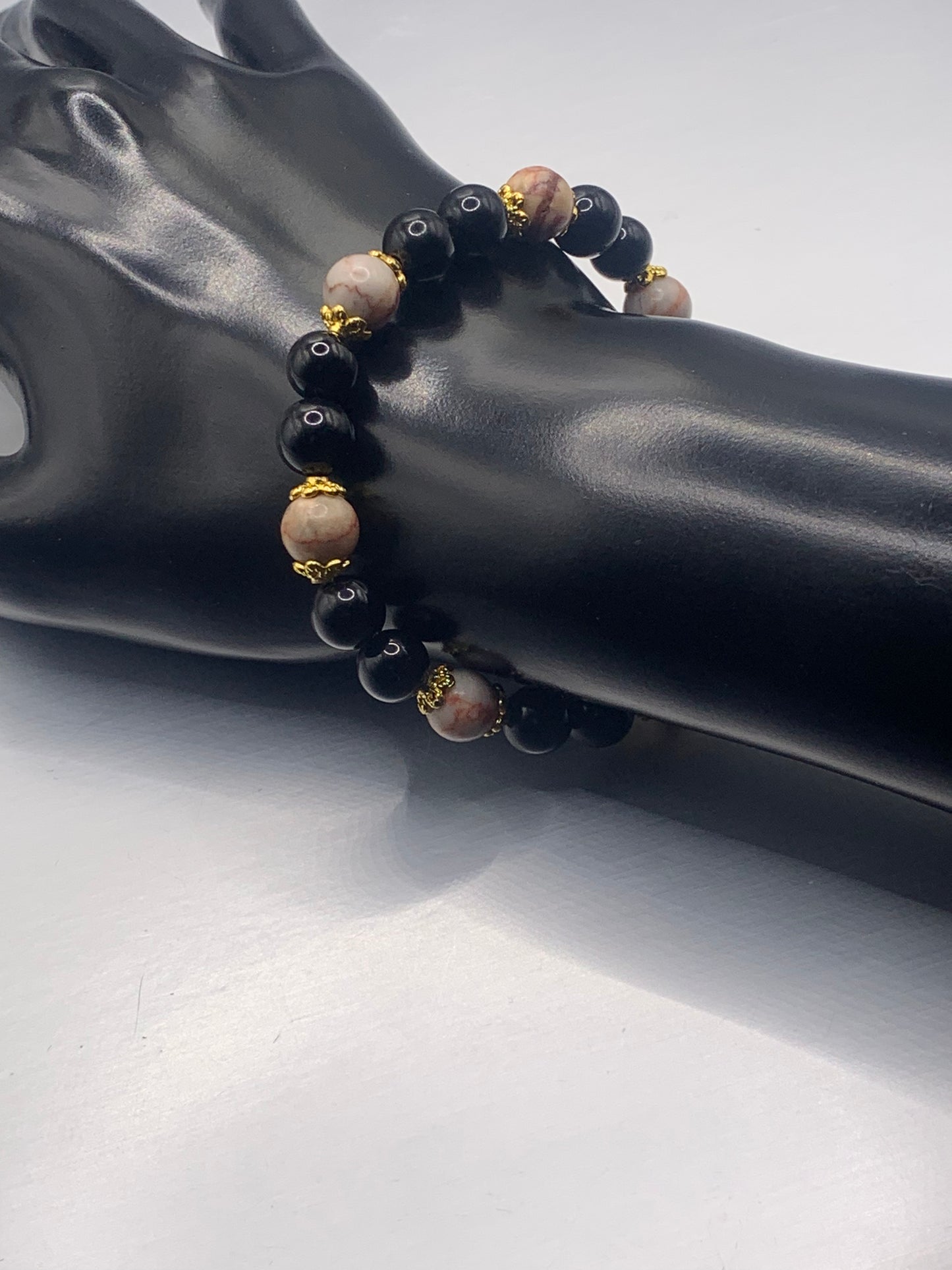 Red vein jasper and black obsidian semi precious stone/crystal elastic beaded bracelet with gold plated flower bead caps