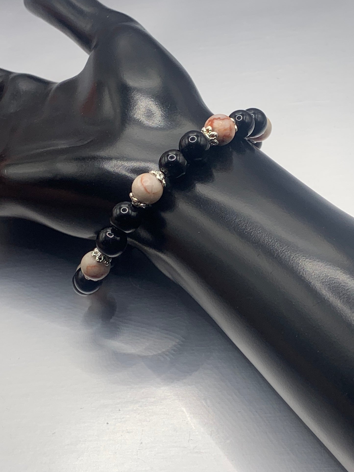 Red vein jasper and black obsidian semi precious stone/crystal elastic beaded bracelet with silver plated flower bead caps