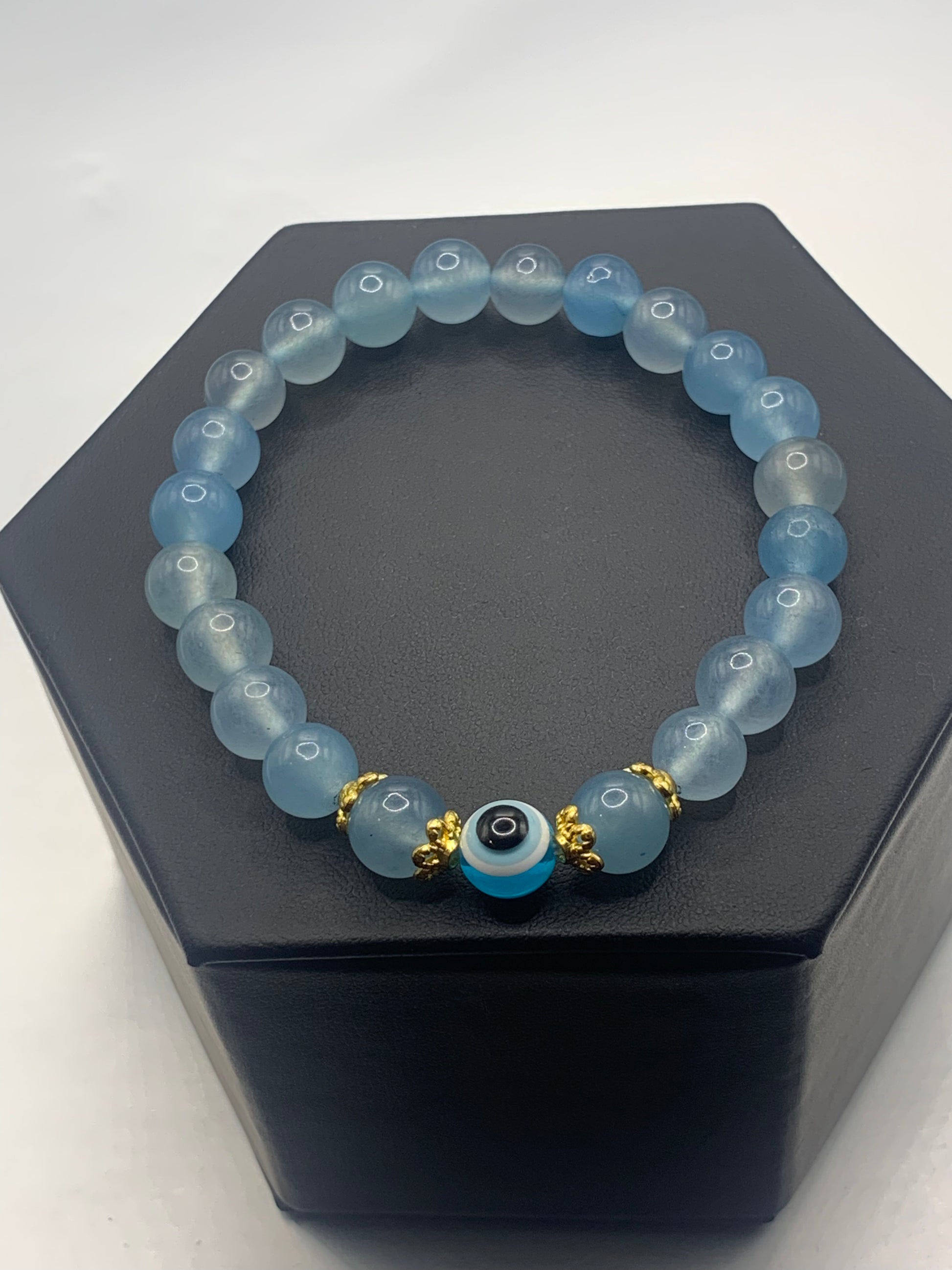 This bracelet features blue agate beads and a colorful evil eye resin bead with gold flower caps. These are 8mm beads, made with elastic string to stretch onto the wrist and is approximately 17 cm or 6.7 inches



These are natural semi-precious stones/crystals. Even if they are dyed, the base material is still natural and imperfections are common making them unique