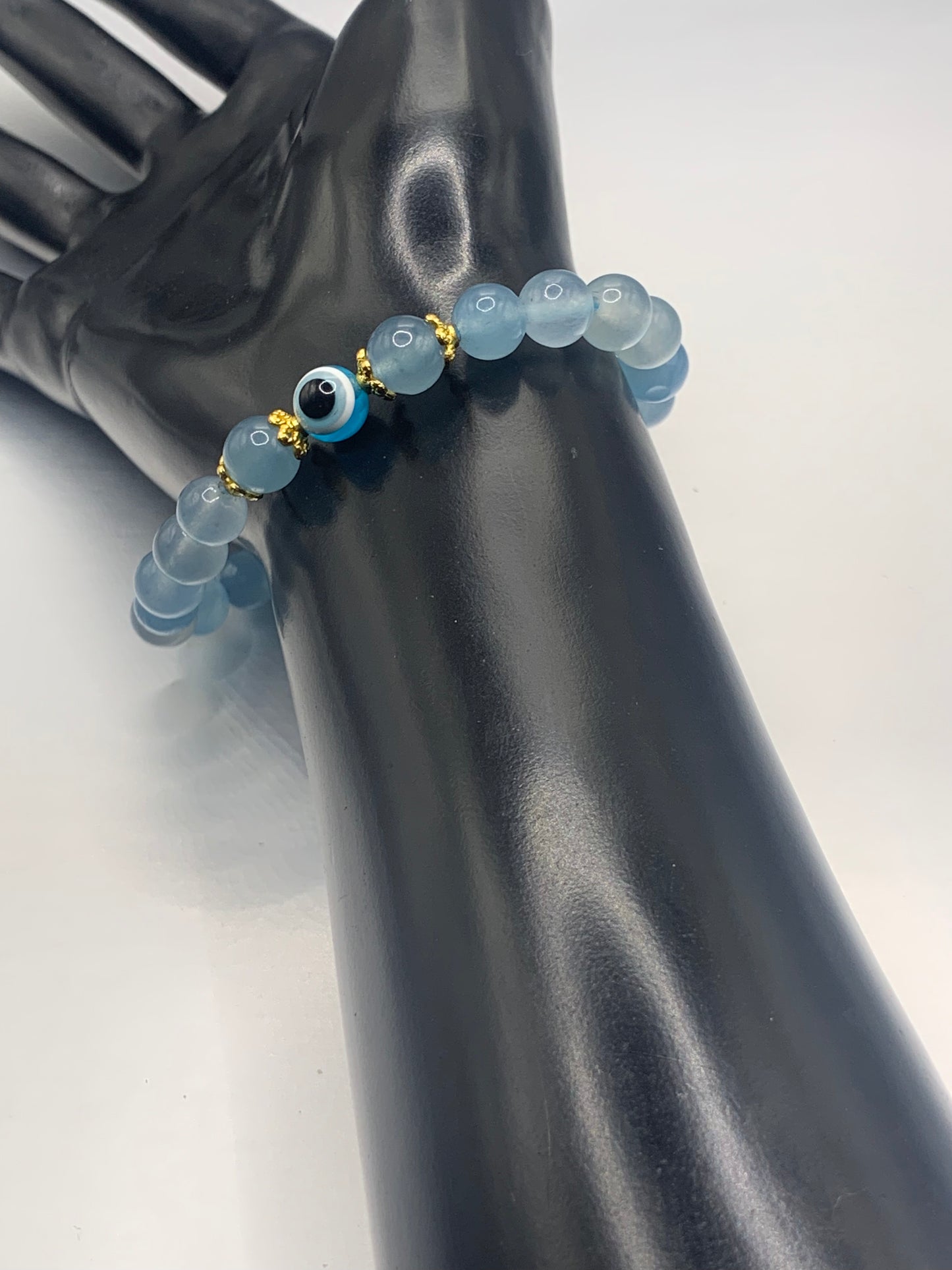 This bracelet features blue agate beads and a colorful evil eye resin bead with gold flower caps. These are 8mm beads, made with elastic string to stretch onto the wrist and is approximately 17 cm or 6.7 inches



These are natural semi-precious stones/crystals. Even if they are dyed, the base material is still natural and imperfections are common making them unique