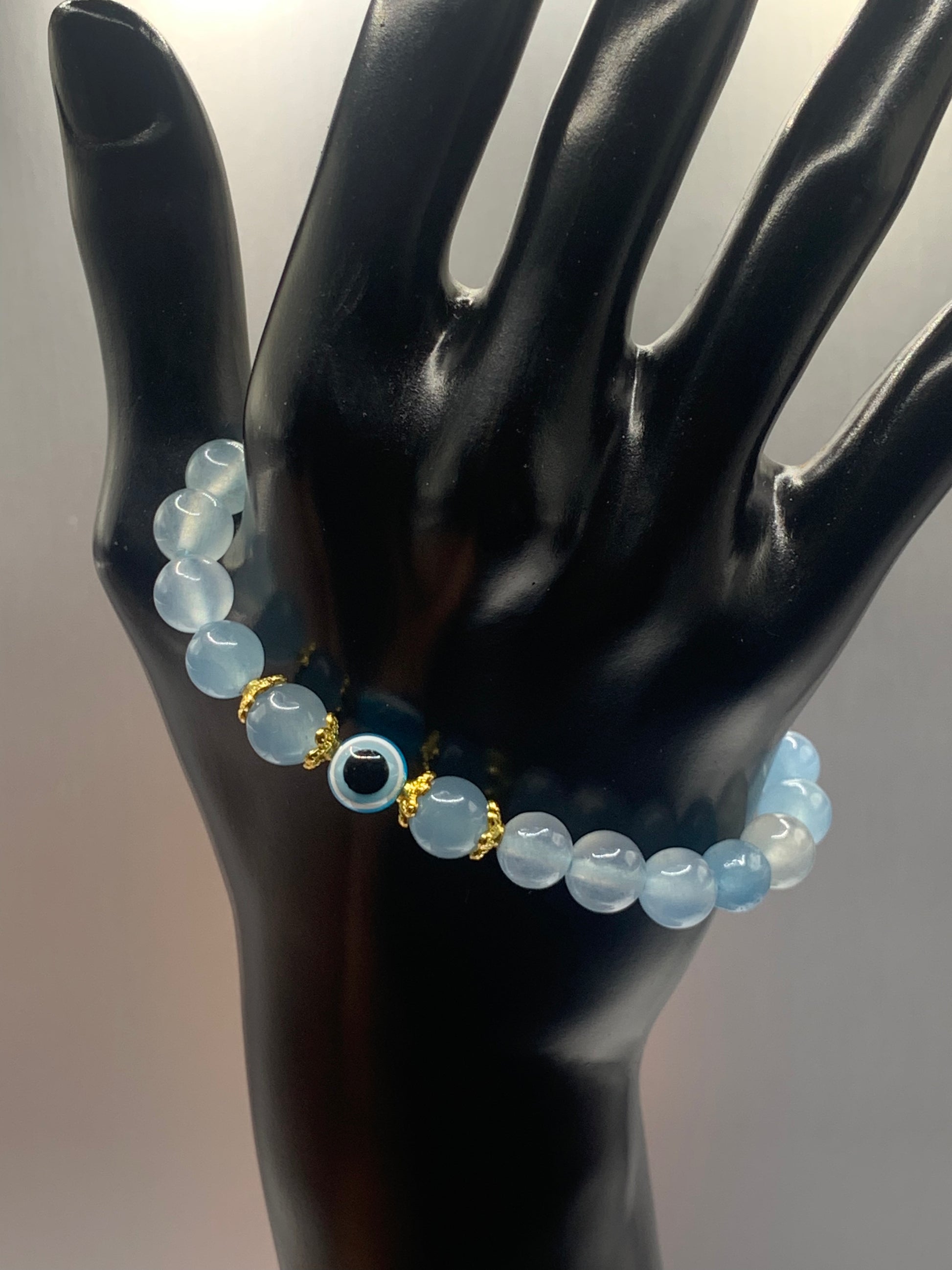 This bracelet features blue agate beads and a colorful evil eye resin bead with gold flower caps. These are 8mm beads, made with elastic string to stretch onto the wrist and is approximately 17 cm or 6.7 inches



These are natural semi-precious stones/crystals. Even if they are dyed, the base material is still natural and imperfections are common making them unique