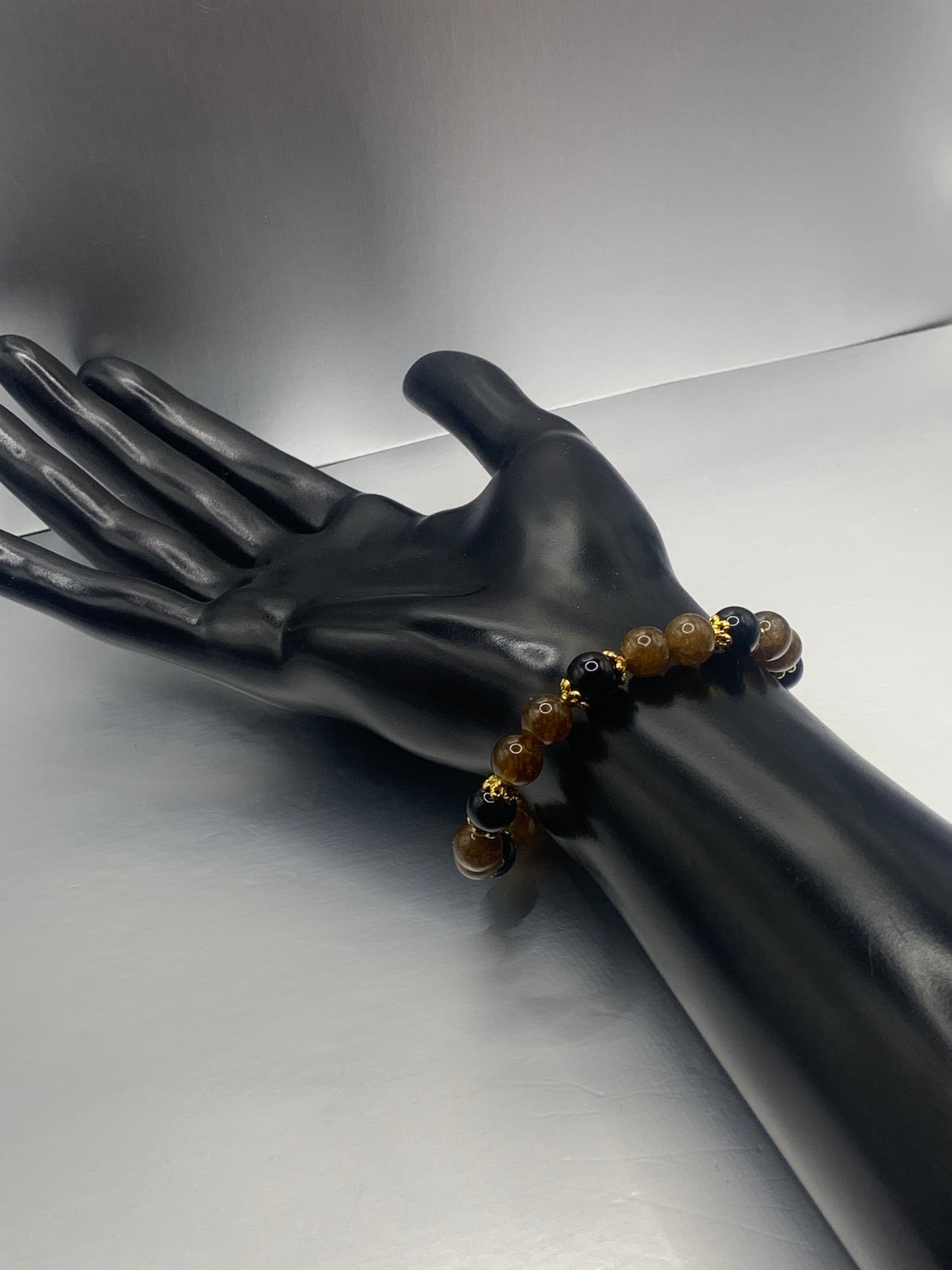 Black obsidian with brown tourmaline semi precious stone/crystal beaded elastic bracelet with gold plated flower bead caps