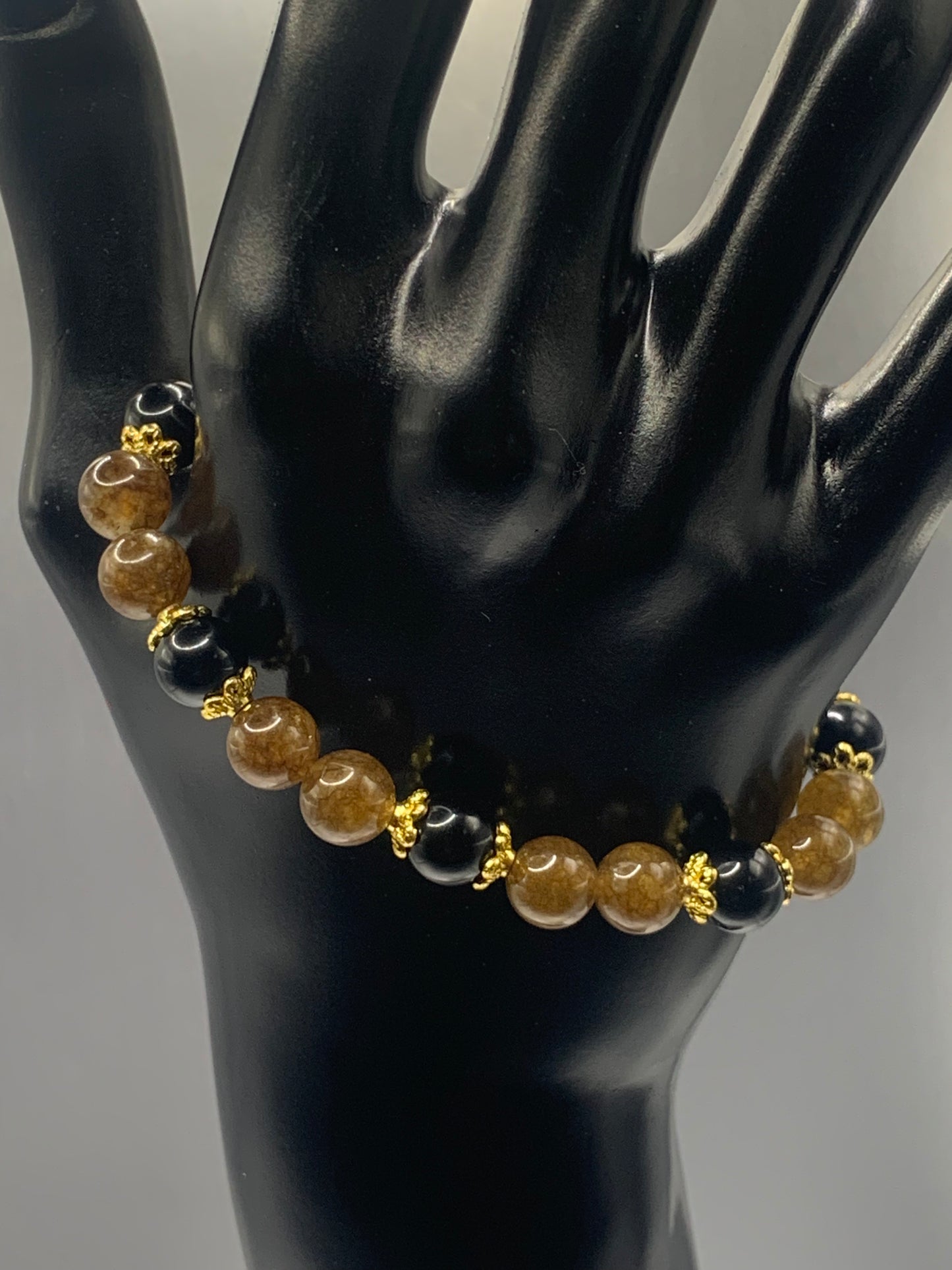 Black obsidian with brown tourmaline semi precious stone/crystal beaded elastic bracelet with gold plated flower bead caps