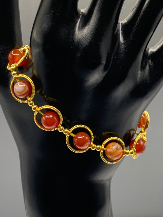 Red agate semi precious stone/crystal elastic beaded bracelet with gold colored rings