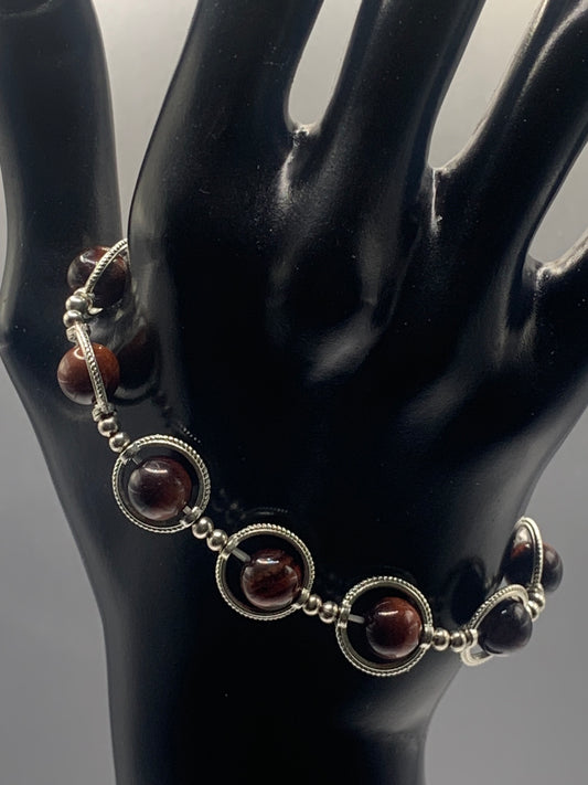 Red tigers eye semi precious stone/crystal elastic beaded bracelet with silver colored rings