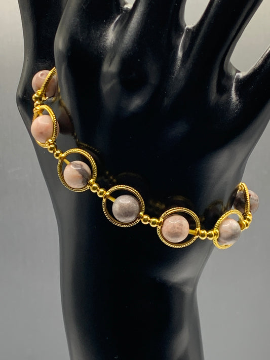 Pink zebra jasper semi precious stone/crystal elastic beaded bracelet with gold colored rings