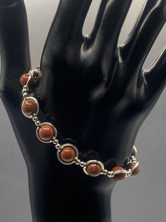 Sandstone semi precious stone/crystal elastic beaded bracelet with silver colored rings
