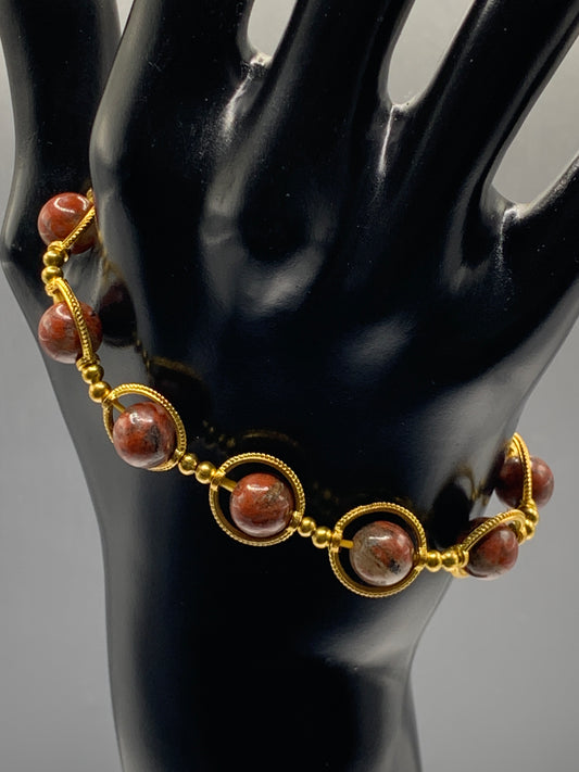 Red sesame jasper semi precious stone/crystal elastic beaded bracelet with gold colored rings