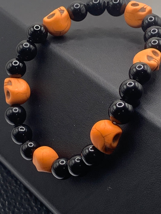 Black obsidian semi precious stone/crystal elastic beaded bracelet with orange resin skulls