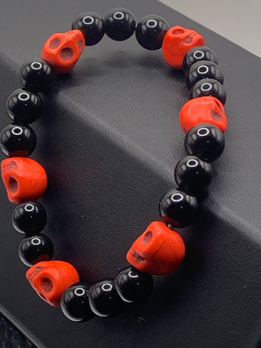 Black obsidian semi precious stone/crystal elastic beaded bracelet with red resin skulls