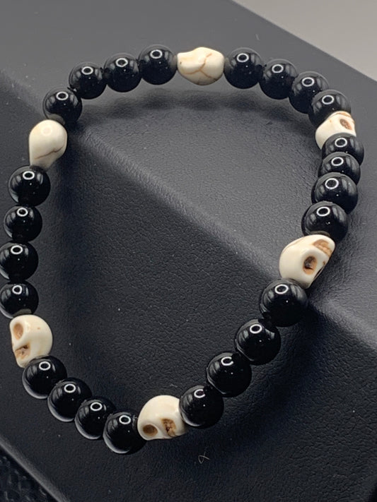 Black obsidian semi precious stone/crystal elastic beaded bracelet with white resin skulls