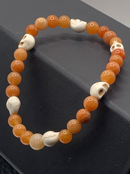 Orange aventurine semi precious stone/crystal elastic beaded bracelet with white resin skulls