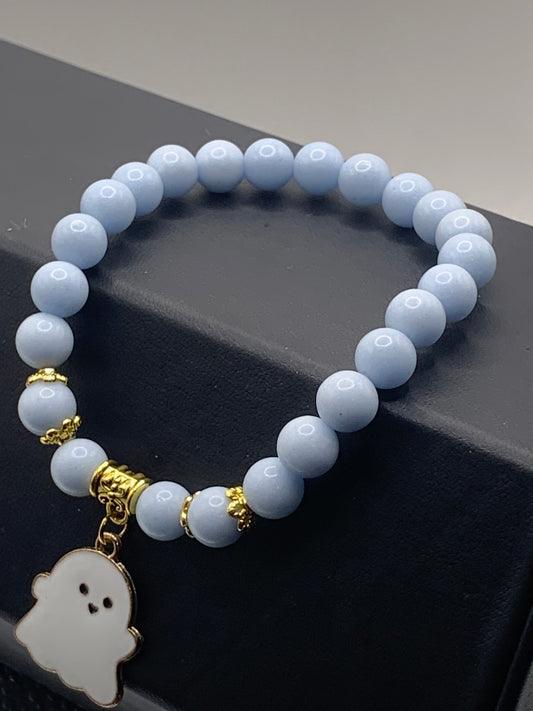 Blue glow-in-the-dark elastic beaded bracelet with a Halloween charm