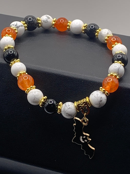 Black obsidian, howlite, and phoenix agate semi precious stone/crystal elastic beaded bracelet with Halloween charm