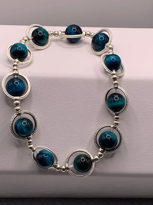 Teal tigers eye semi precious stone/crystal elastic beaded bracelet with silver colored rings