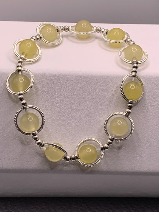 Yellow agate semi precious stone/crystal elastic beaded bracelet with silver colored rings
