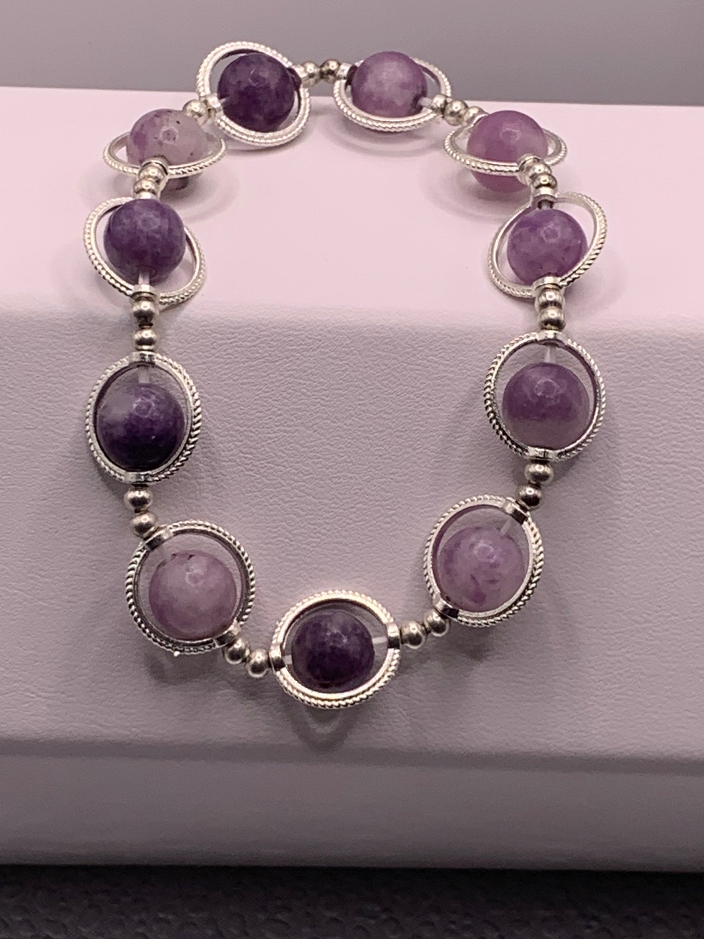 Purple mica semi precious stone/crystal elastic beaded bracelet with silver colored rings