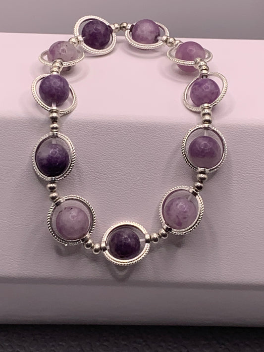 Purple mica semi precious stone/crystal elastic beaded bracelet with silver colored rings