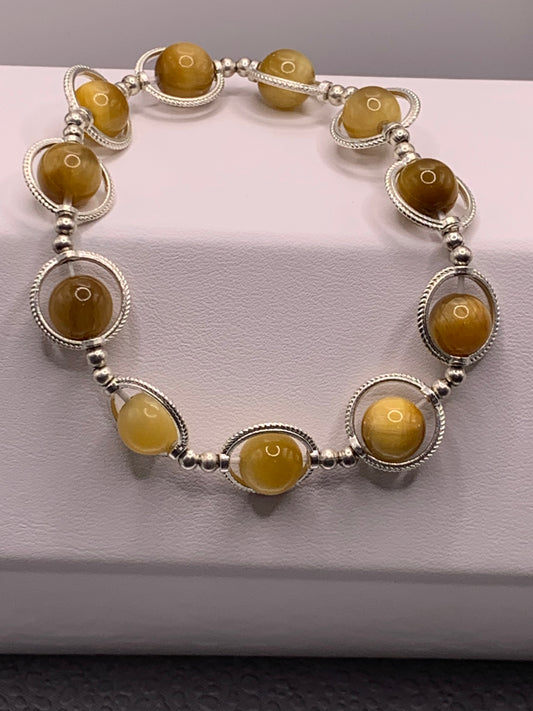Yellow tigers eye semi precious stone/crystal elastic beaded bracelet with silver colored rings
