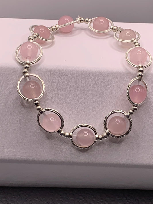 Rose quartz semi precious stone/crystal elastic beaded bracelet with silver colored rings