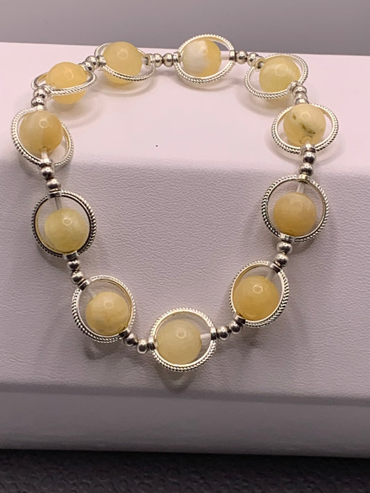 Yellow calcite semi precious stone/crystal elastic beaded bracelet with silver colored rings